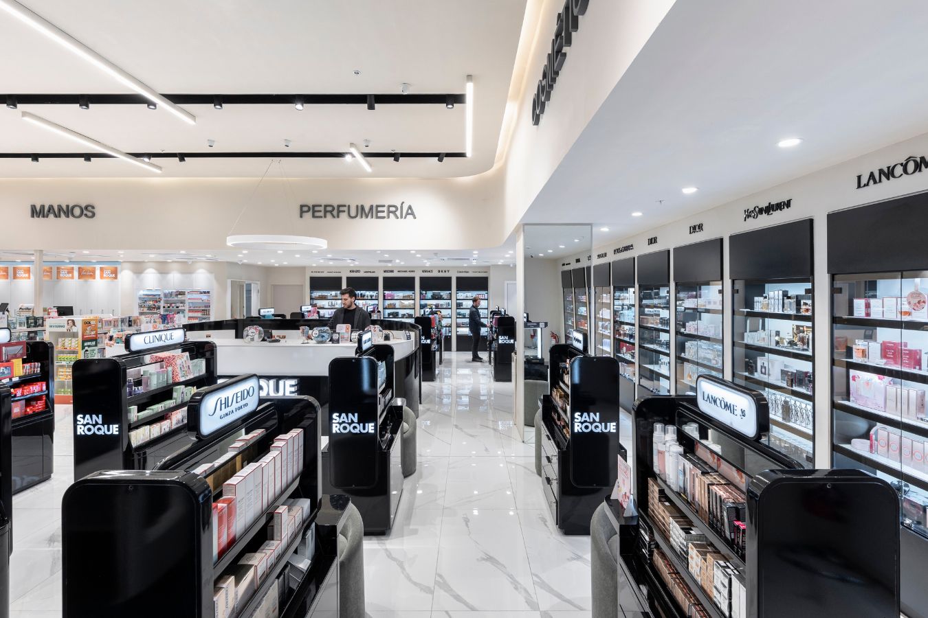 San Roque Pharmacy - Beauty and cosmetics section with illuminated black display units - Contract Workplaces.jpg